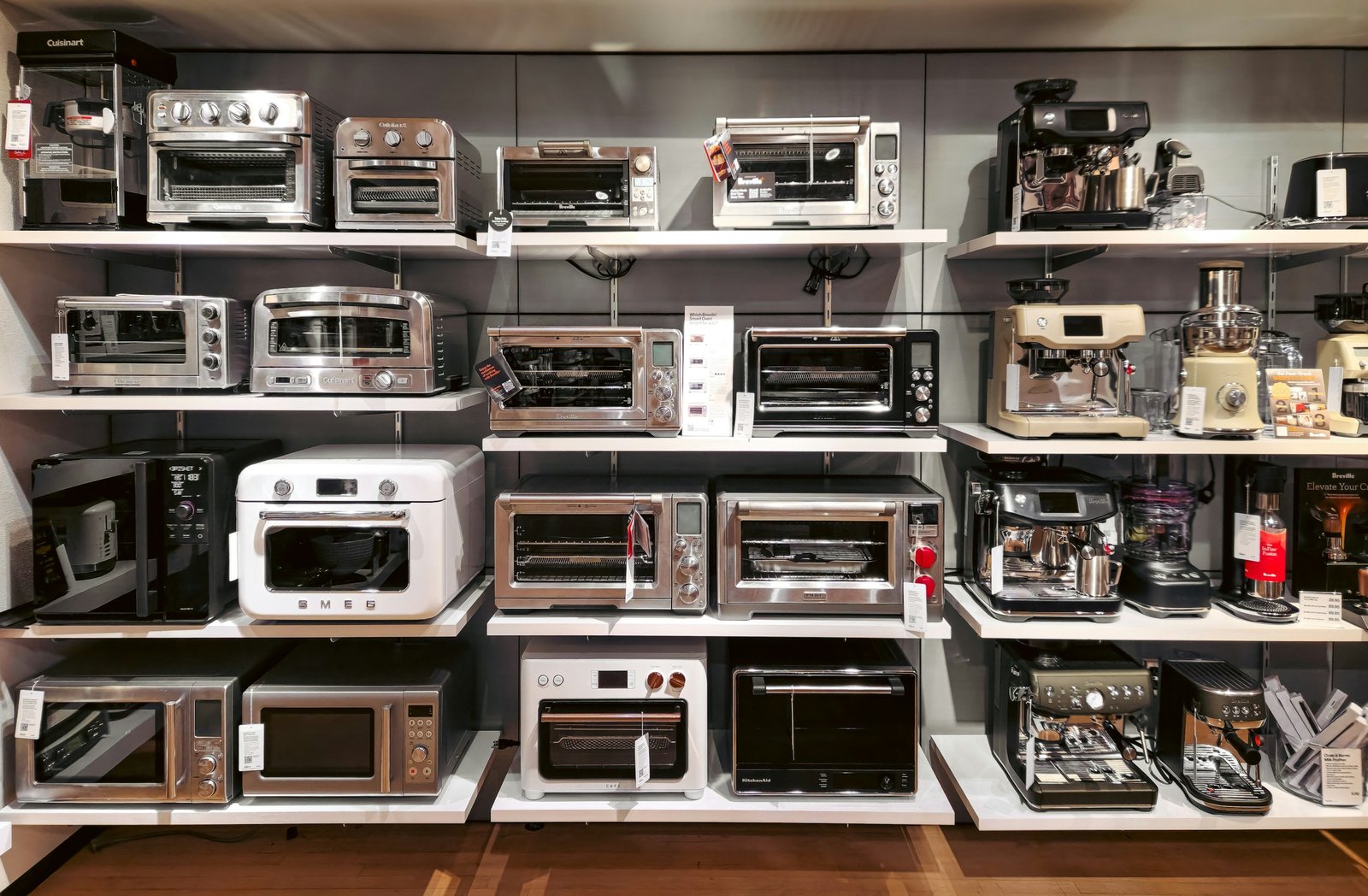 Showroom shelves stocked with ovens, microwaves and coffee machines