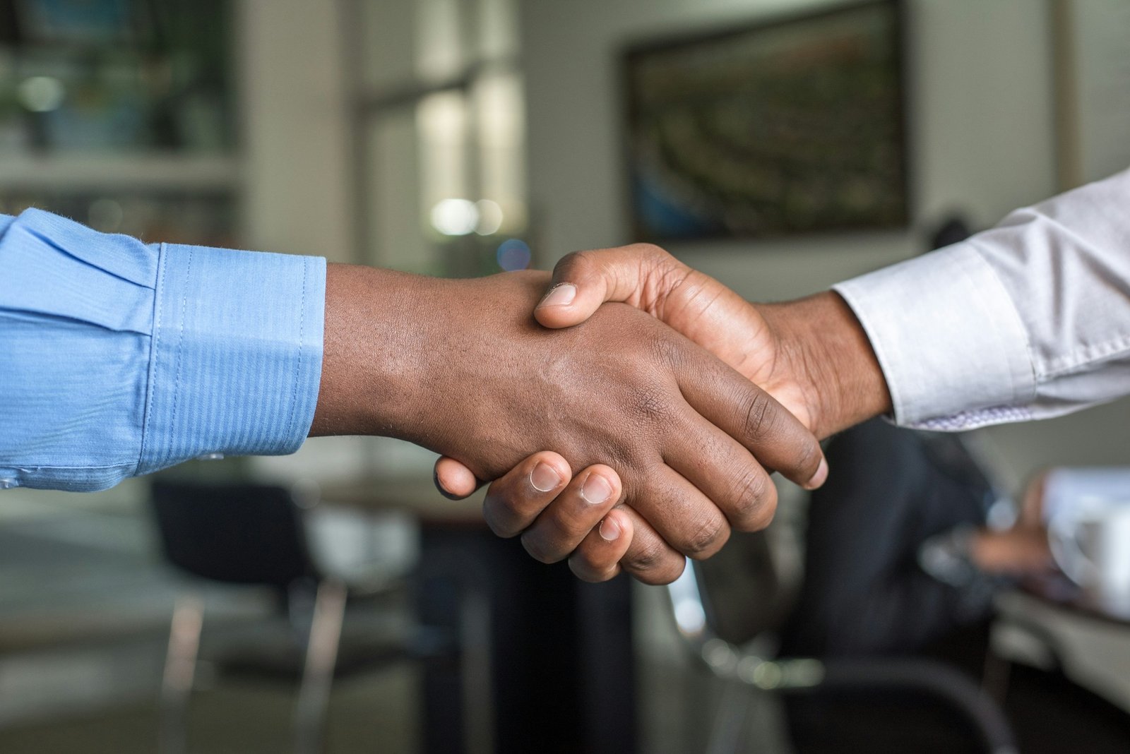 Two people shaking hands on a supply agreement